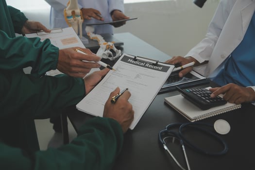 Group of doctors reading a document in meeting room at hospital photo