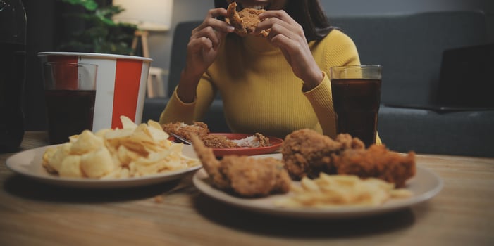 fat woman bite piece of pizza,overweight female is eating fast foods,asian girl is hungry photo