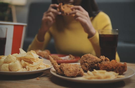 fat woman bite piece of pizza,overweight female is eating fast foods,asian girl is hungry photo