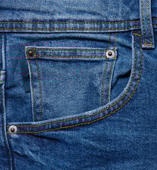 Blue jeans front pocket with buttons, close up photo