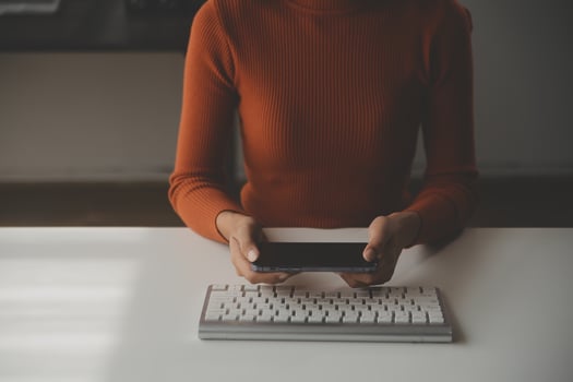 Asian Businesswoman Using laptop computer and working at office with calculator document on desk, doing planning analyzing the financial report, business plan investment, finance analysis concept. photo
