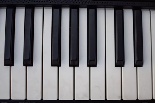 Close-up of piano keys. Piano black and white keys and Piano keyboard musical instrument placed at the home balcony during sunny day. photo
