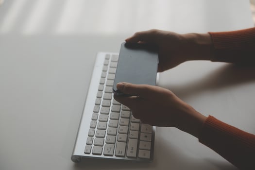 Asian Businesswoman Using laptop computer and working at office with calculator document on desk, doing planning analyzing the financial report, business plan investment, finance analysis concept. photo