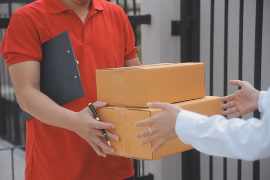 Asian Woman Receiving Product from delivery man at Home, Young Owner Woman Order Product from Smartphone Application, Woman with Online Business or SME Concept. photo