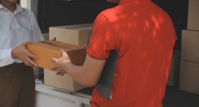 Asian Woman Receiving Product from delivery man at Home, Young Owner Woman Order Product from Smartphone Application, Woman with Online Business or SME Concept. photo