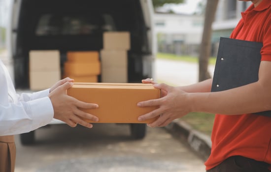 Asian Woman Receiving Product from delivery man at Home, Young Owner Woman Order Product from Smartphone Application, Woman with Online Business or SME Concept. photo