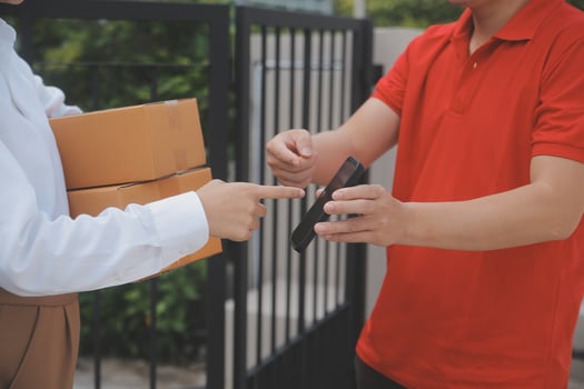 Asian Woman Receiving Product from delivery man at Home, Young Owner Woman Order Product from Smartphone Application, Woman with Online Business or SME Concept. photo