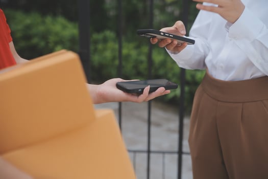 Asian Woman Receiving Product from delivery man at Home, Young Owner Woman Order Product from Smartphone Application, Woman with Online Business or SME Concept. photo