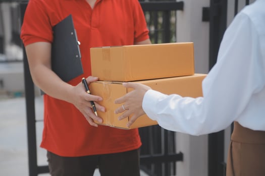 Asian Woman Receiving Product from delivery man at Home, Young Owner Woman Order Product from Smartphone Application, Woman with Online Business or SME Concept. photo