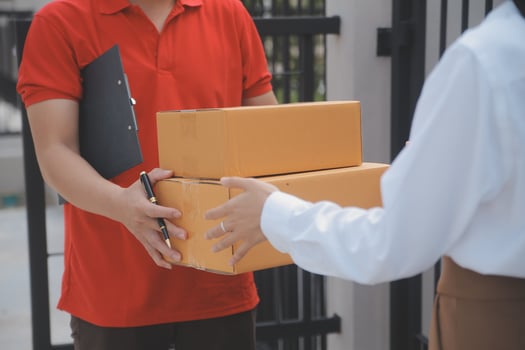 Asian Woman Receiving Product from delivery man at Home, Young Owner Woman Order Product from Smartphone Application, Woman with Online Business or SME Concept. photo