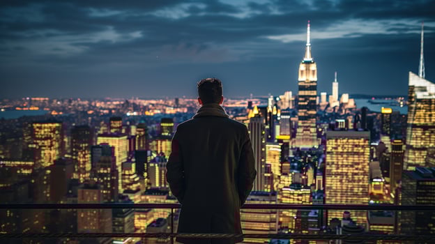 Thoughtful man looking out at city skyline photo