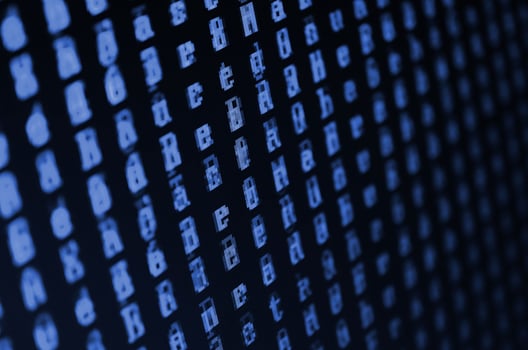 Macro shot of a glitch on the monitor of an office computer. The concept of introducing a virus into a personal data keeper. Stream of random green symbols. phantom classic blue color. photo