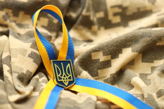 Military camouflage fabric with ukrainian stripes on ribbon photo