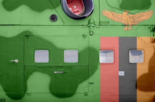 Zambia flag depicted on side part of military armored helicopter closeup. Army forces aircraft conceptual background photo
