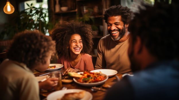 Family gathered around a table, smiling photo