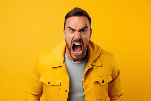 annoyed man gestures angrily, expresses negative emotions with mouth widely opened. Angry expression photo