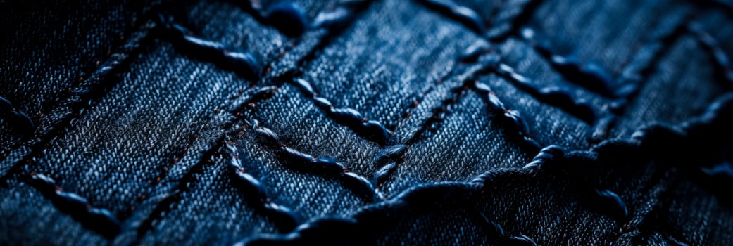 Detailed macros highlighting meticulous stitch patterns on textured denim backgrounds photo