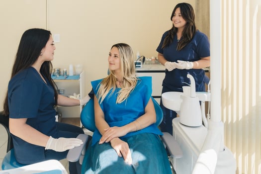 Woman smiling during her dental treatment at dentist. photo