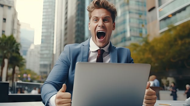 Young businessman in a successful suit shouts with joy Receive notifications from your laptop photo