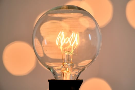 Incandescent light bulb with christmas round bokeh. photo