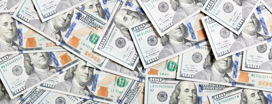 Top view of one hundred dollar banknotes made as a background. USD currency concept. Texture of American dollars photo