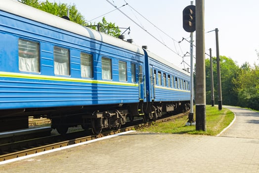 Old blue train is leaving the platfrom at the railway station photo