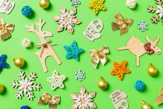 Top view of green background with New Year toys and decorations. Christmas time concept photo