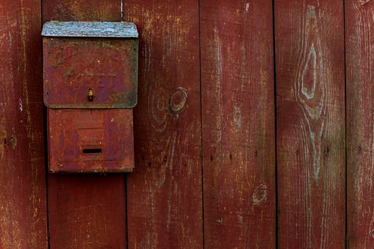 For letters and newspapers. Translation of the Russian text. Mail box on the wooden fence red photo