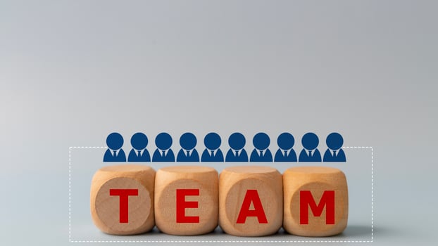 Wooden cube with a business team icon with the word team. Business teamwork and synergy concept. photo