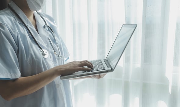 Doctor working with laptop computer in medical workspace office. doctor working on laptop computer in modern clinics office. search medical information. banner copy space photo