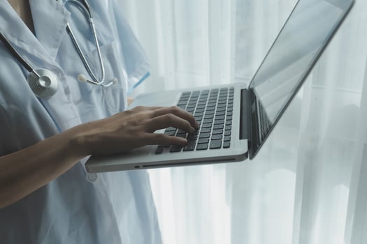 Doctor working with laptop computer in medical workspace office. doctor working on laptop computer in modern clinics office. search medical information. banner copy space photo