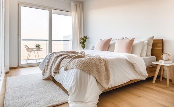 Comfortable bed with blanket in light bedroom with parquet floor and bedside table placed near windows in modern apartment. Generative AI photo