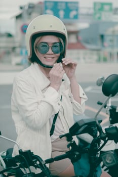 woman wearing safety helmet standing on city road toothy smile with happiness face photo