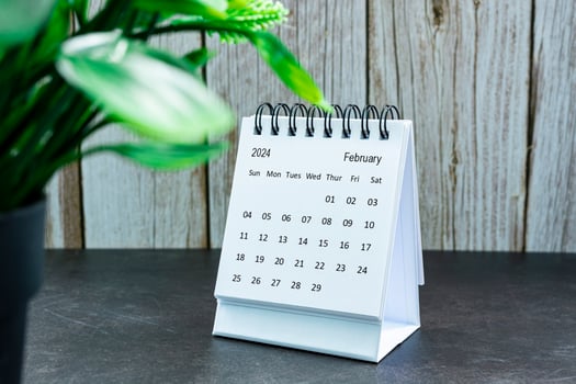 White February 2024 calendar on wooden desk. 2024 New Year Concept photo