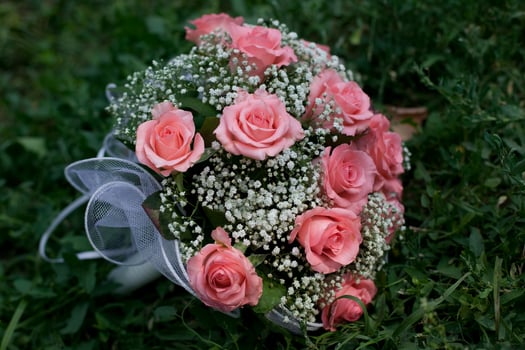 Bridal bouquet lying on the green grass photo