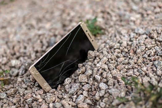 broken phone on stone paved sidewalk outdoors. Lost on walk smartphone with broken screen photo