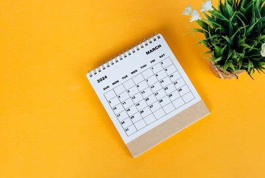 March 2024 desk calendar on yellow background. Directly above. Flat lay. photo