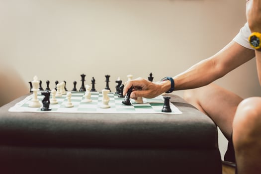 Man playing chess board game at home. photo