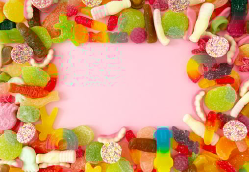 Creative background made of gummy candies with copy space. Colorful flat lay. Jelly sweets aesthetic. photo