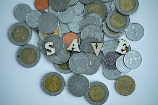 Flat wooden text written SAVE with many baht coins with white background, Close up, Finance concept. photo