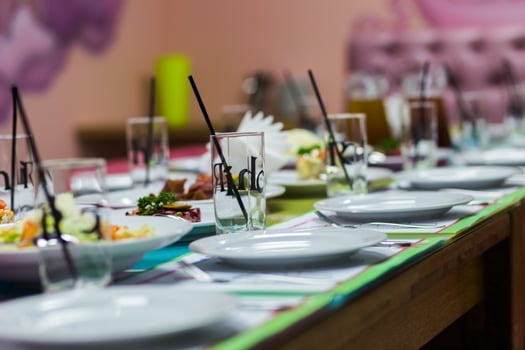 Serving table in the children's cafe. Plates and glasses on a ta photo