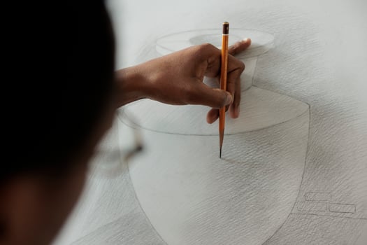 Close up of student hand holding pencil practicing sketching techniques while studying at art school, people developing drawing skills. Artist creating sketch, creating artwork photo