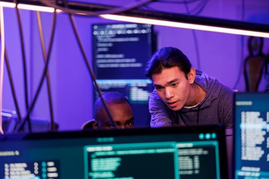 Criminals hacking into computer system while planning cyberattack and discussing phishing technique. Hackers doing ddos attack to break website and running malware code on screen photo