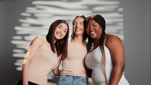 Group of diverse girls feeling positive about body types, laughing and having fun together on camera. Models with different skintones and body shapes promoting body confidence and self acceptance. photo