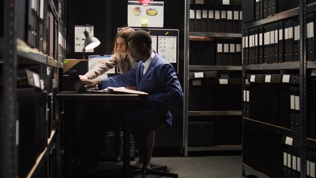 Male detective inspector and female private investigator debating over confidential criminal case. Two police officers investigate the crime by analysing clues and obtaining information. photo