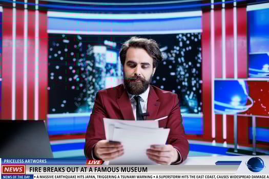 Anchorman reveals museum on fire breaking news, many artifacts and artworks are in danger of burning. News broadcaster being worried about historical pieces at famous landmark. photo