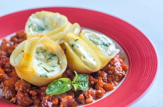 Lumaconi stuffed with ricotta with bolognese sauce photo