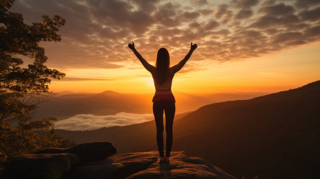 Woman stretching with sunrise in the background photo
