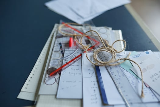 collection of office supplies, pencils, paper, pens, and work. photo