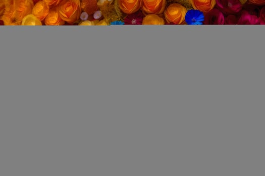 a colorful wall with many different colored flowers. AI-Generated photo